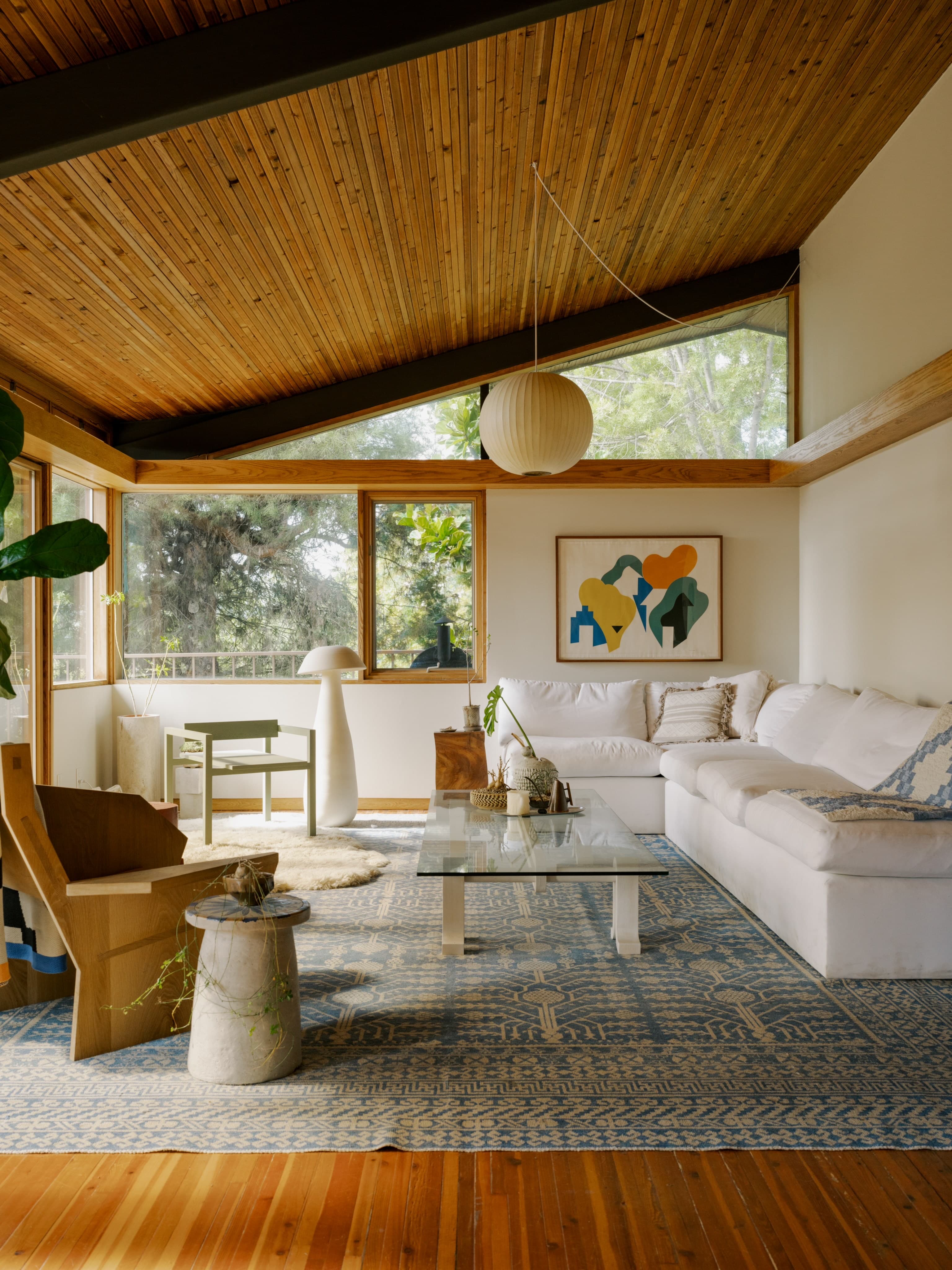 Mid-century modern living room with blue Oriental rug by Aja Rugs